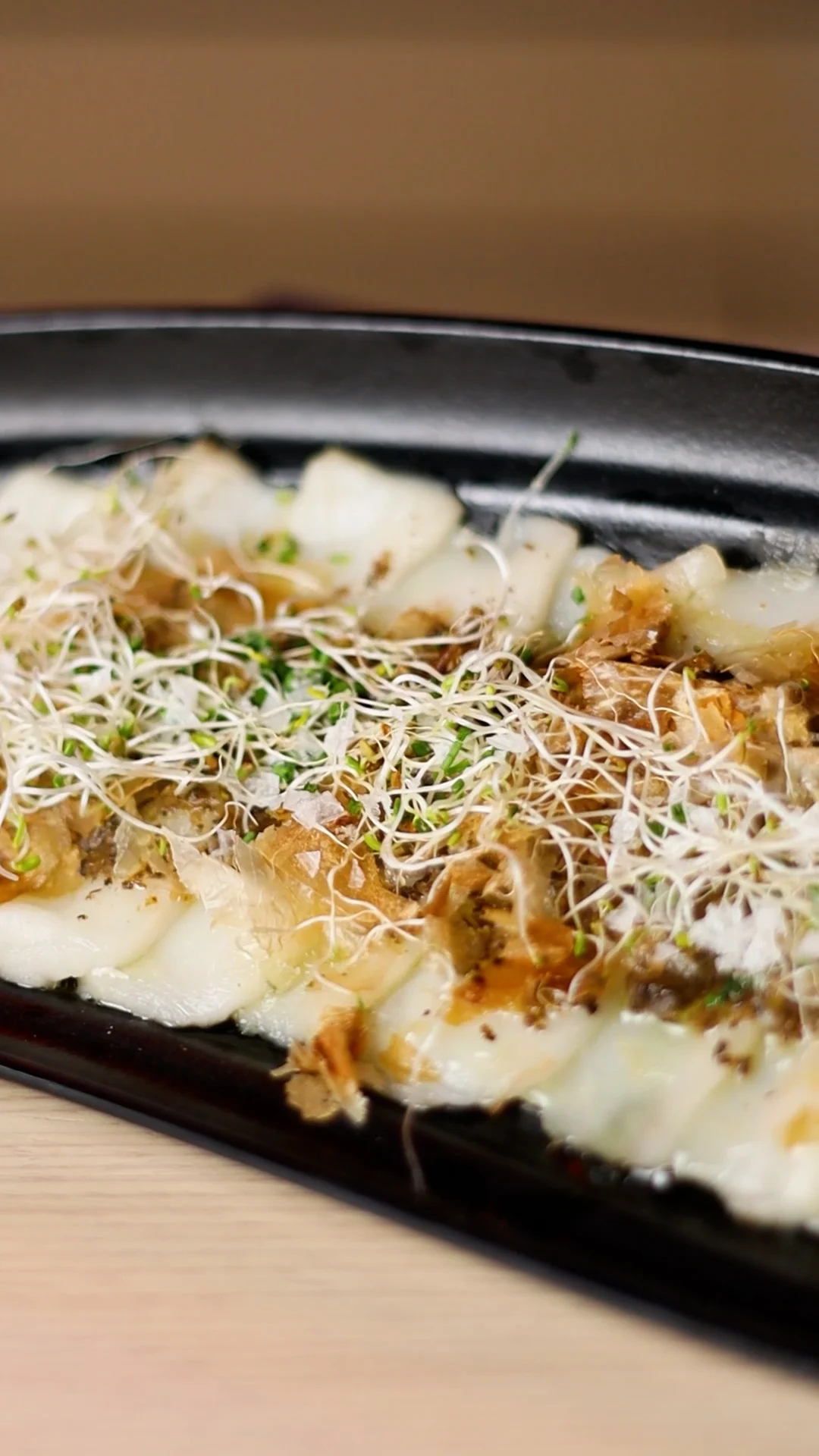 Cold Sliced Butterfish with Truffle Sauce, Dried Bonito Flakes and Alfalfa Sprouts