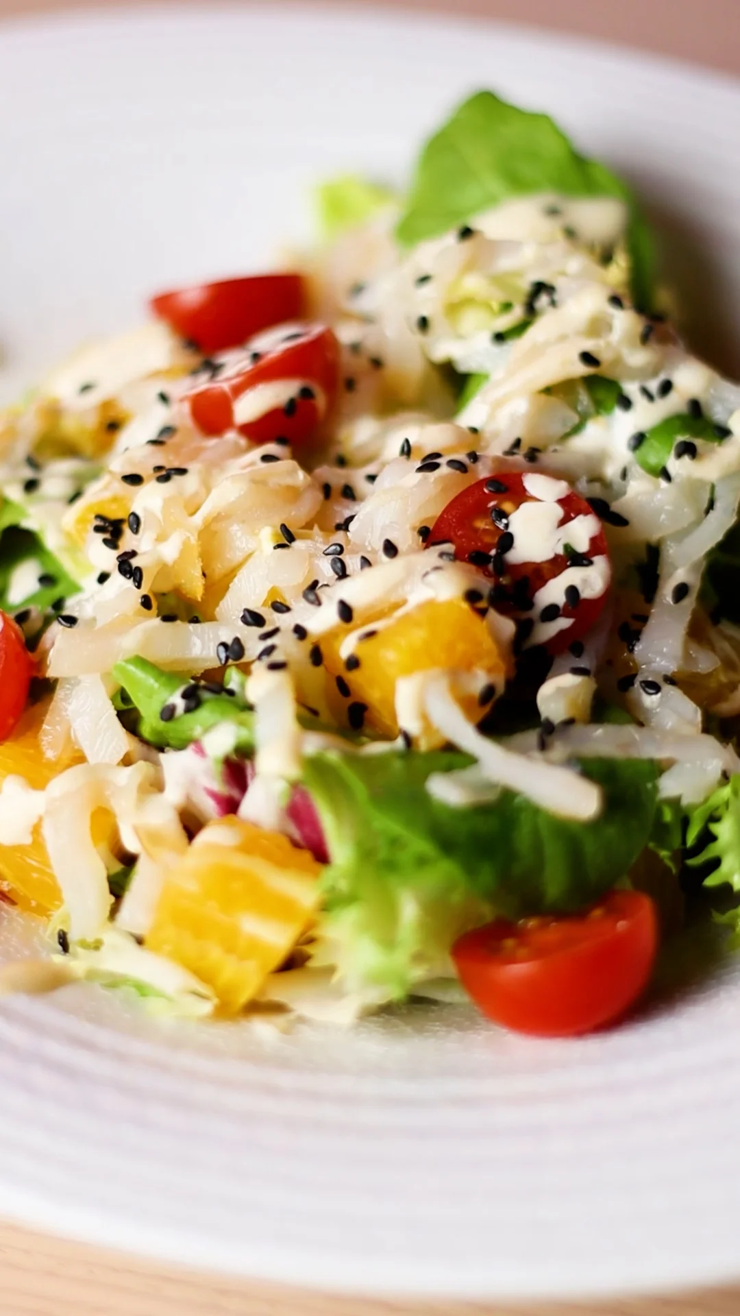 Leaves Salad: Mixed Greens with Valencian Orange Cubes, Smoked Cod Shavings, Cherry Tomatoes and Fried Egg Cream with Black Sesame