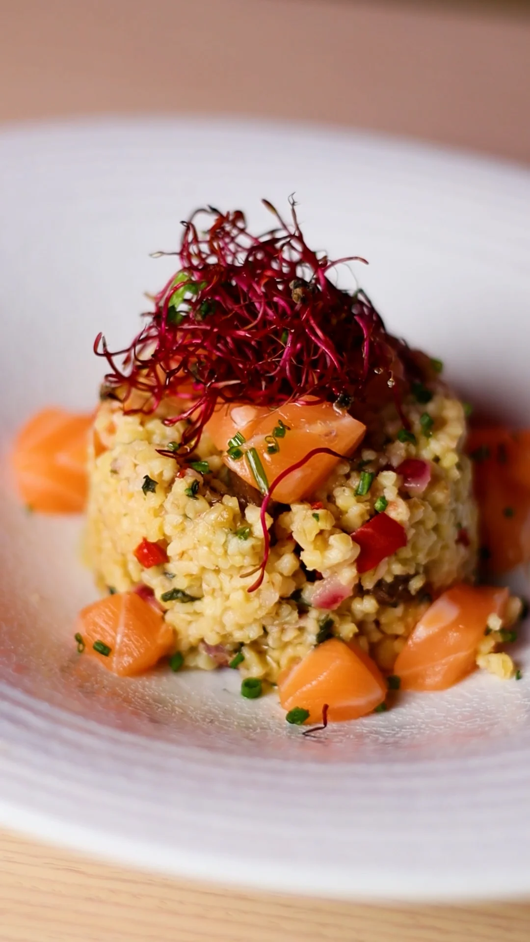Oriental Tabbouleh Poke Bowl with Sultana Raisins and Fresh Salmon Cubes with Sprouts