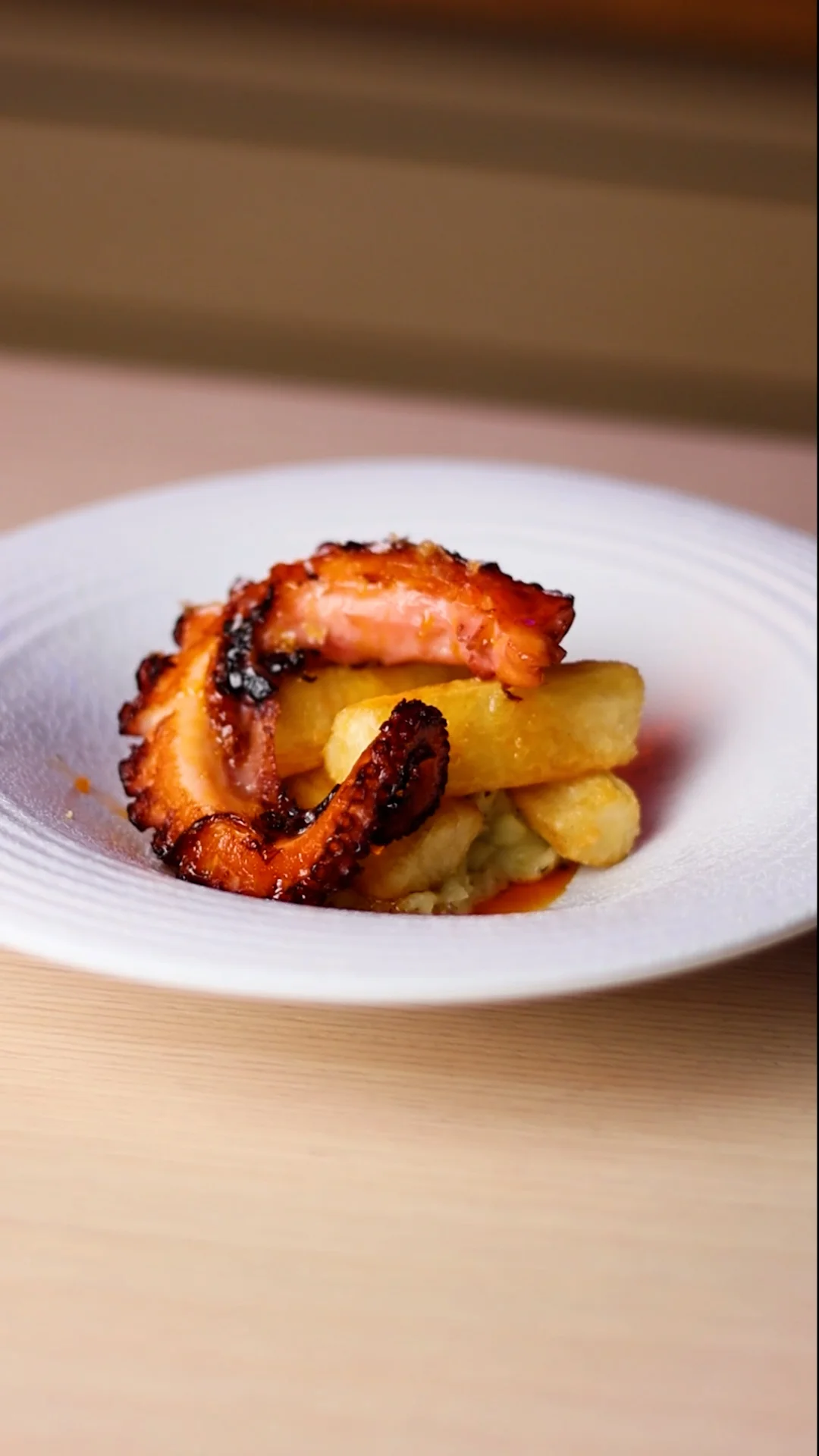 Grilled Octopus on Truffle Cream, Crispy Yuca Batons and Galician Garlic Oil Drops