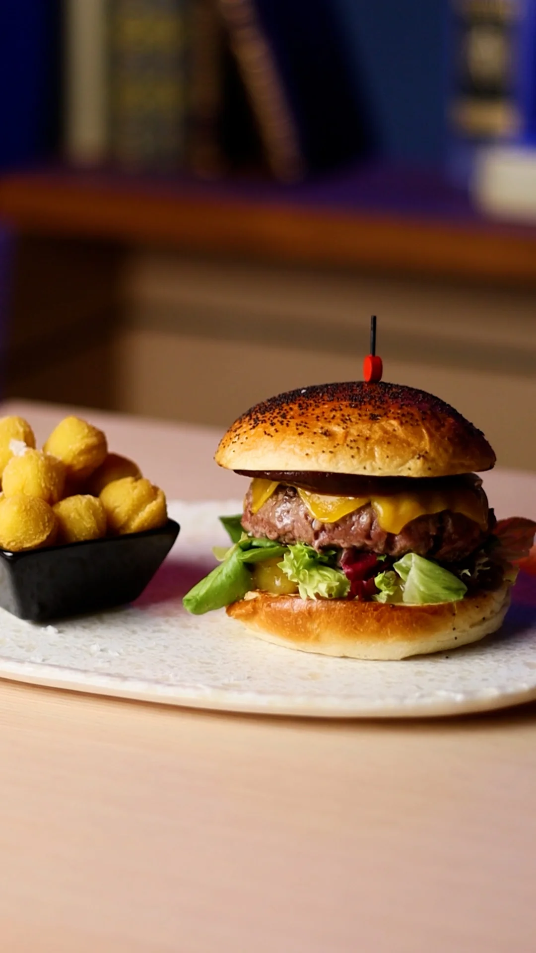 Simmental Beef Burger in Poppy Seed Brioche with Kansas BBQ Sauce, English Cheddar, Mixed Greens and Pineapple Jam (Served with Potato Balls)