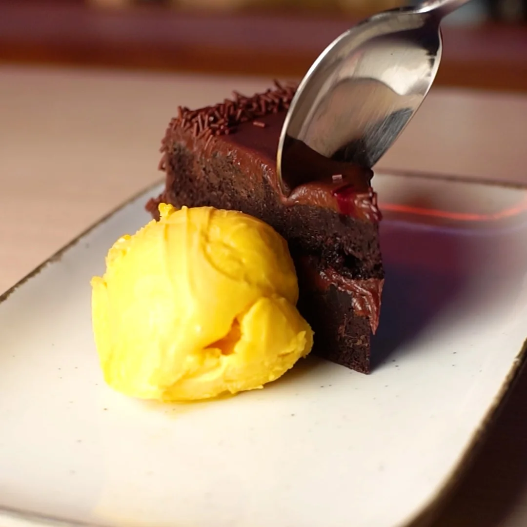 Chocolate cake with mango ice cream